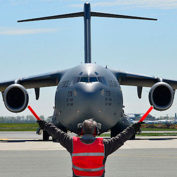 Airman marshalling a C-17 Globemaster I (U.S. Air Force photo by Airman 1st Class William Johnson/Released)