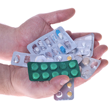 Hands holding pill packets